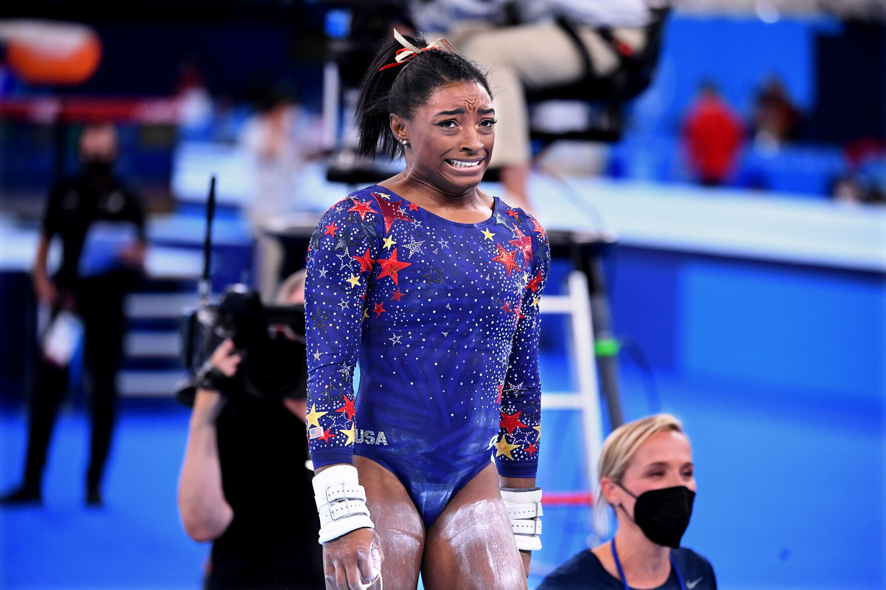 U.S. gymnast Simone Biles reacts after competing on the uneven bars in the women's team qualifying at the 2020 Tokyo Olympics on Sunday, July 25, 2021.